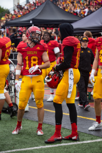 Gryphon player on the sideline during homecoming game.