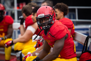 Gryphon player on the sideline during homecoming game.