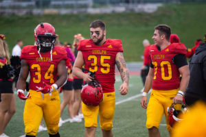 Gryphon players walk on the field in between halves at the homecoming game.