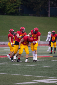 Gryphon players walk on the field in between plays at the homecoming game.