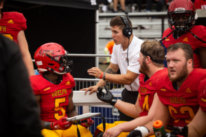 Gryphon player on the sideline during homecoming game.