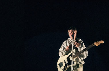 Clairo playing guitar at Danforth Music Hall