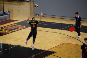 Arjun Selhi, #9, jumps to serve the ball at the men's volleyball game against the Windsor Lancers on Dec. 1.