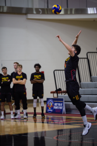 Gideon Dresser, #4, jumps to serve the ball at the men's volleyball game against the Windsor Lancers on Dec. 1.