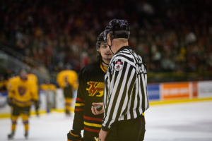 #43 listens to the referee in between plays.