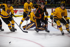 #16 Chris Brill-Morgan tries to recover the puck in front of the Laurier net.