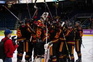 Guelph Gryphons celebrate after winning their match against Laurier 4-3.