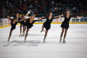 Figure skaters hold hands during Frosty Mug 2020