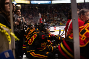 #25 Ryan Da Silva sitting on the bench with his team mates.