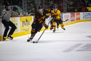#24 Bobby Dow skates with the puck across the blue line