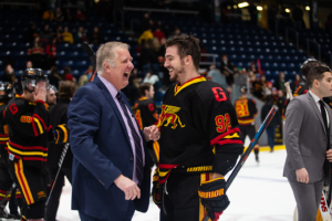 Assistant Coach Andrew DeGroot celebrates with #92 Giordano Finoro after winning Frosty Mug 2020.