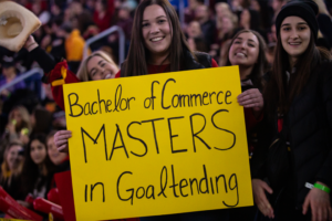 Girl holding sign that read "Bachelor of Commerce, Masters in Goaltending" at Frosty Mug 2020.